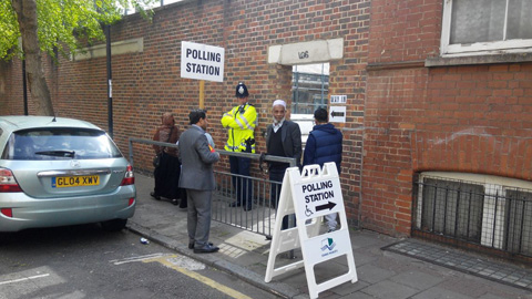 Police stand guard in front of the Kobi Nazrul Primary School in Tower Hamlets