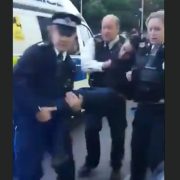 A bystander filmed police carrying an unconscious Khan into their police van