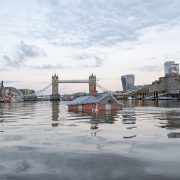 The future? Earlier this month Katey Burak and Rob Higgs from Extinction Rebellion installed a sinking house into the Thames as a protest against current planning by councils Pic: Guy Reece
